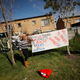 A resident puts up a banner as community members gather in a park to discuss gang violence in Manenberg township, Cape Town